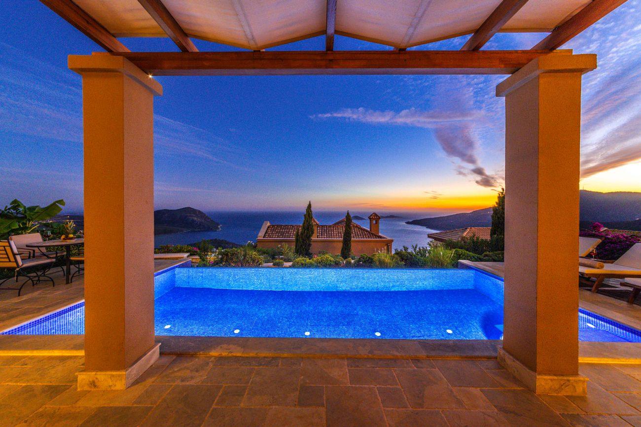 Poolside outdoor living space with discreet architectural speakers