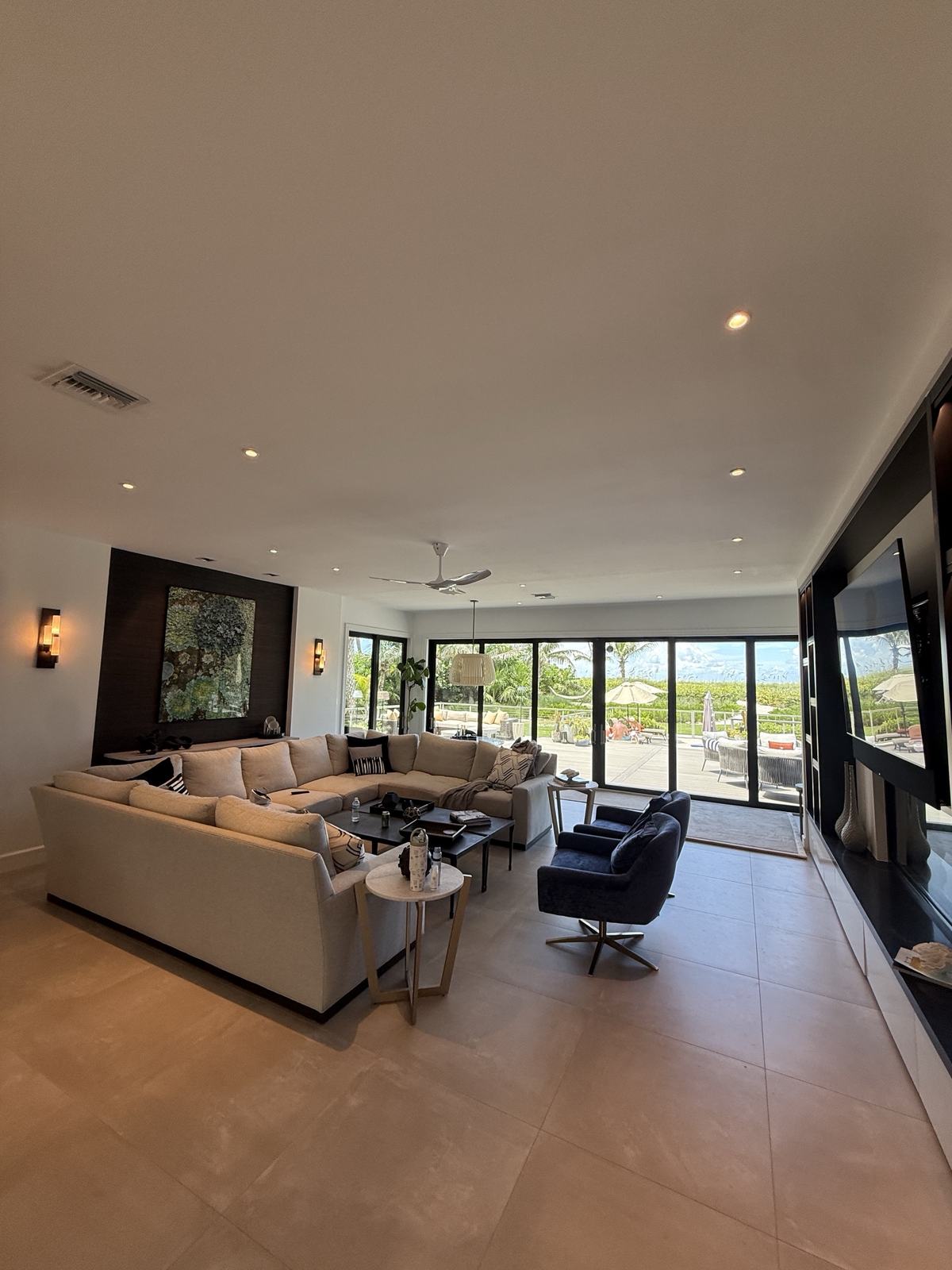 CES project — luxury living room with layered recessed lighting and pool view